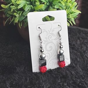 Red, black and silver pendant earring with fish hook ear post.